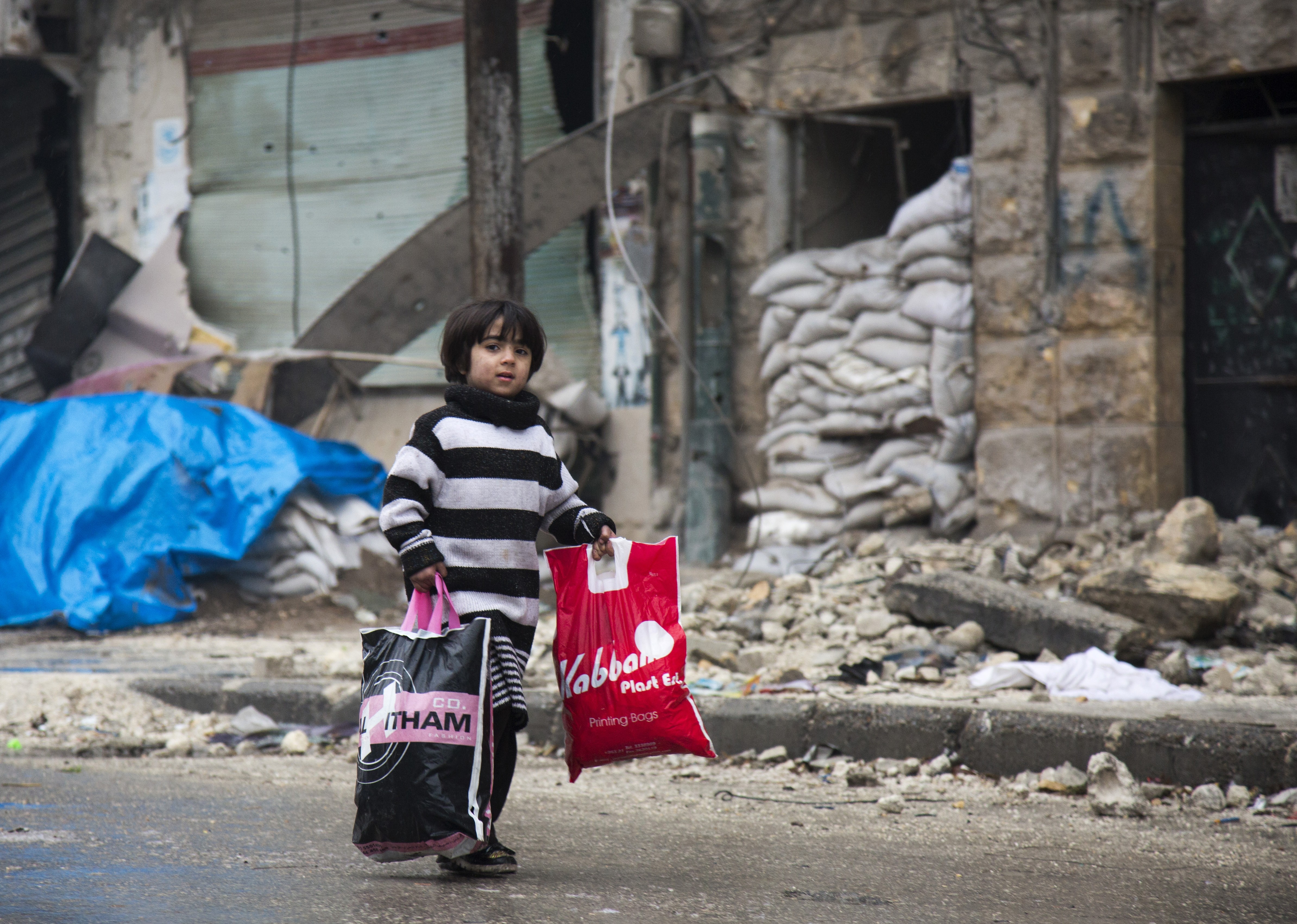 A Syrian boy is seen among other civilains leaving a rebel-held area of Aleppo towards the government-held side on December 13, 2016. Image credit: AFP A Syrian boy is seen among other civilains leaving a rebel-held area of Aleppo towards the government-held side on December 13, 2016. Image credit: AFP